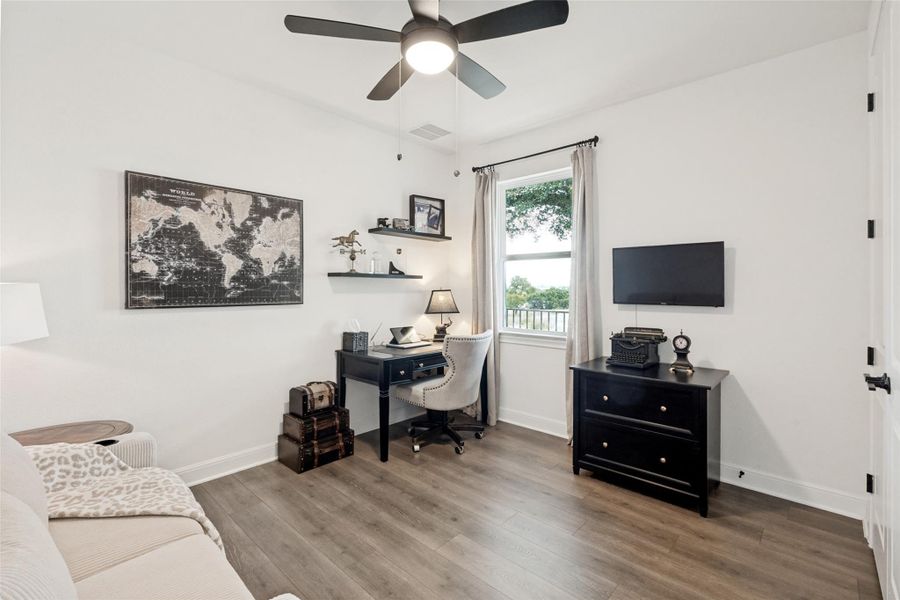 Smooth wood flooring and a classic window frame this versatile home workspace.