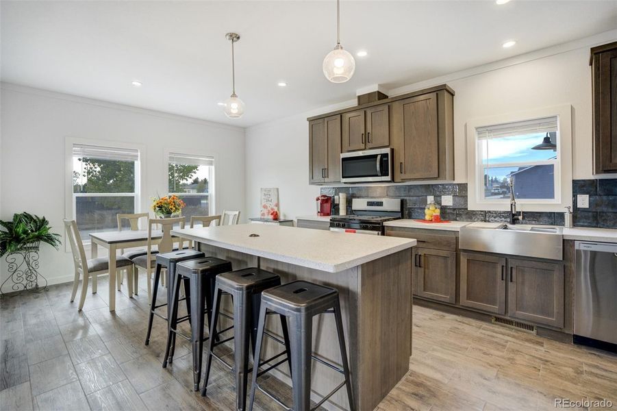 Large island provides for extra dining, prep space, or homework spot.