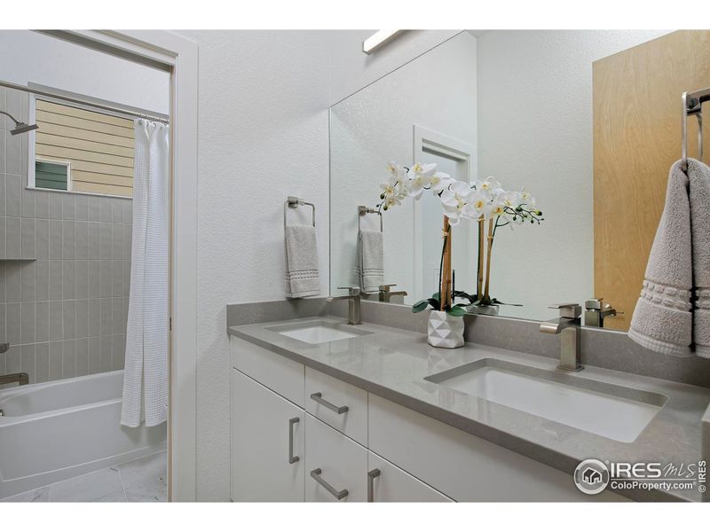 Secondary bathroom with dual vanity & Quartz countertops Secondary bathroom with dual vanity & Quartz countertops