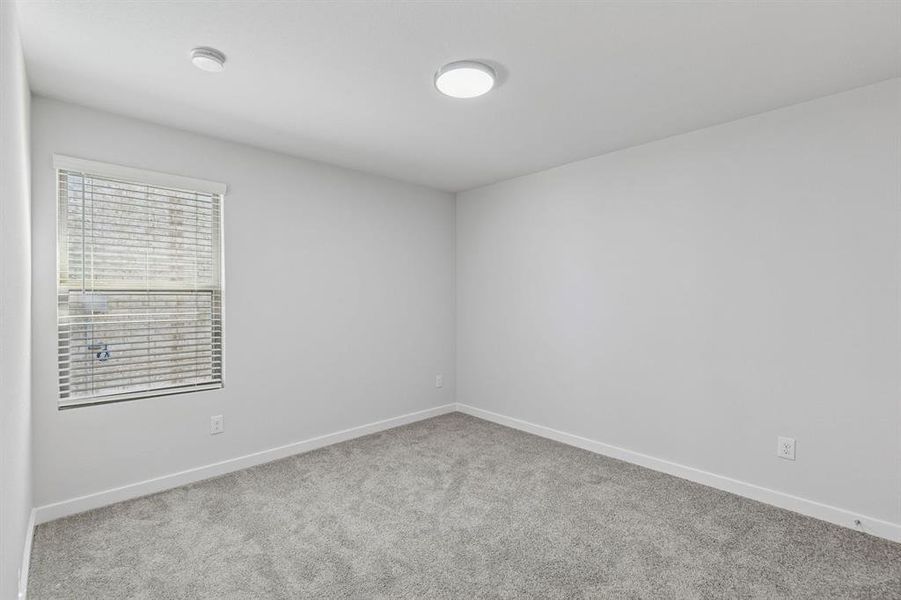 Bedroom in the Harrison home plan by Trophy Signature Homes – REPRESENTATIVE PHOTO