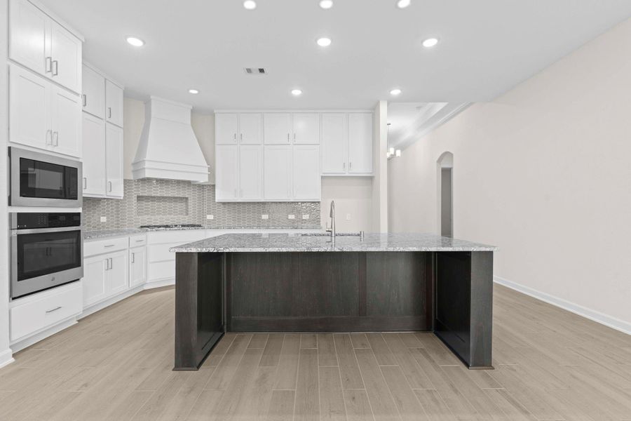 Chef-inspired kitchen complete with built-in oven, gas cooktop, convection oven, and stainless steel appliances, designed for both style and functionality.