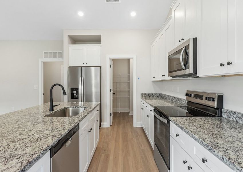 The kitchen has designer wood cabinetry The kitchen has designer wood cabinetry