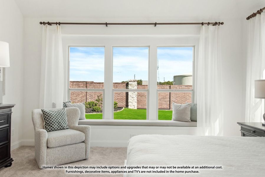 Bedroom with triple windows, built-in window seat, accent chair, and backyard view Bedroom with triple windows, built-in window seat, accent chair, and backyard view