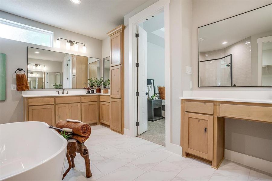 Bathroom featuring a freestanding bath, a stall shower, recessed lighting, marble finish floor, and vanity Bathroom featuring a freestanding bath, a stall shower, recessed lighting, marble finish floor, and vanity