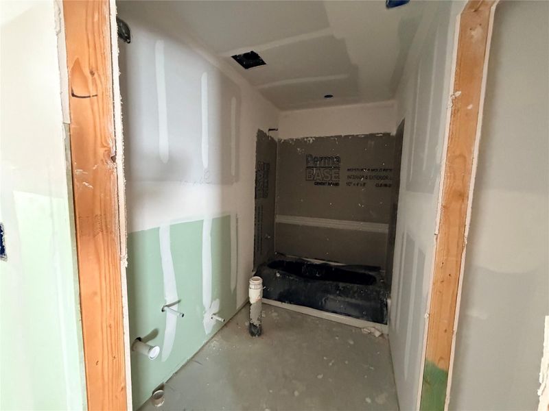 A partially completed bathroom awaits your personal touch to create a luxurious retreat.