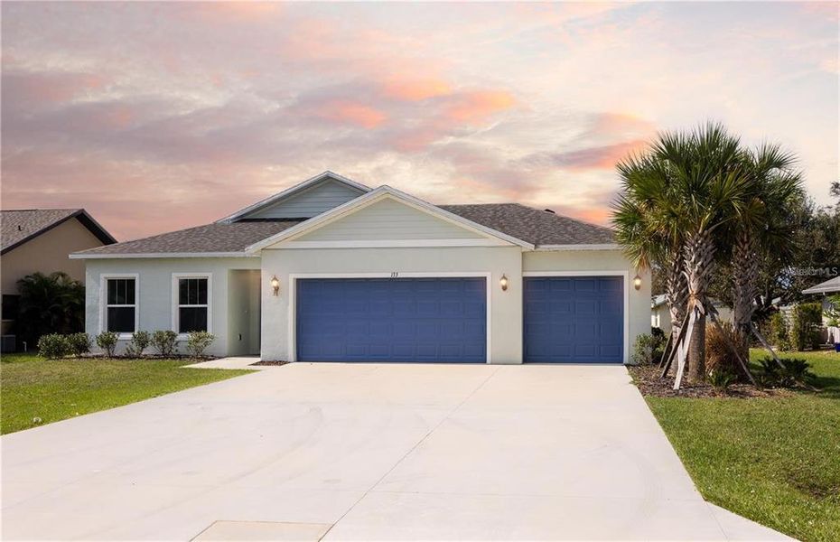 Front exterior of a new home in , Punta Gorda, FL, highlighting curb appeal (Image 1).