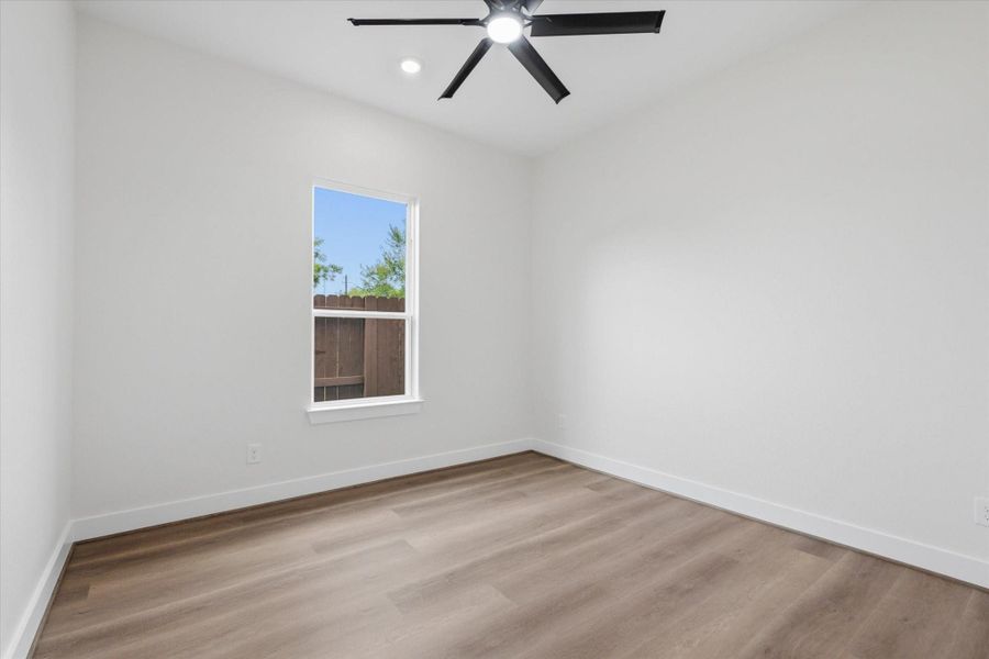 Each secondary bedroom offers clean lines, continuous vinyl flooring, and a black ceiling fan with a couple of recessed lights. Each secondary bedroom offers clean lines, continuous vinyl flooring, and a black ceiling fan with a couple of recessed lights.