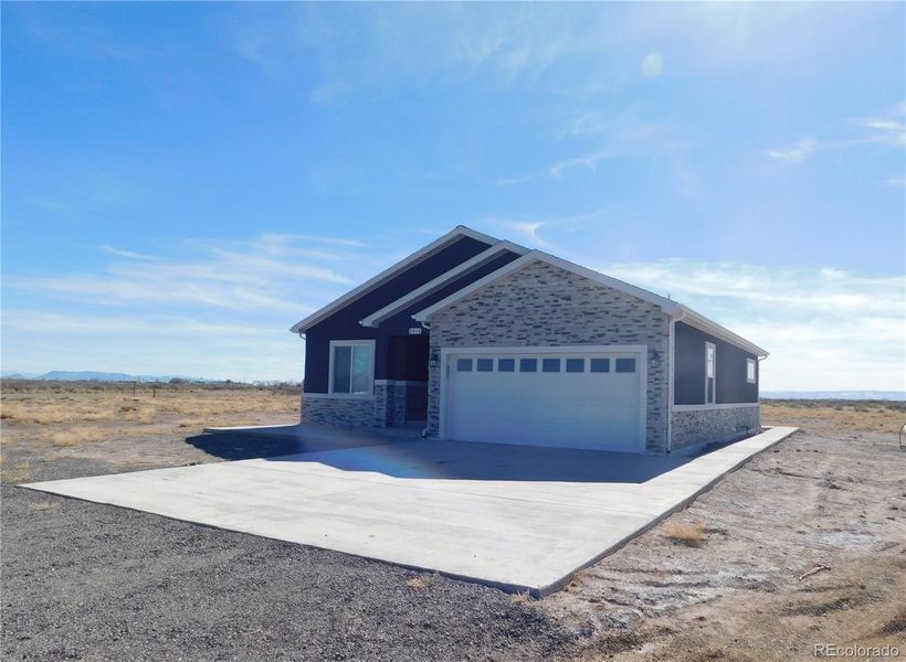 Front exterior of a new home in , Alamosa, CO, highlighting curb appeal (Image 2).