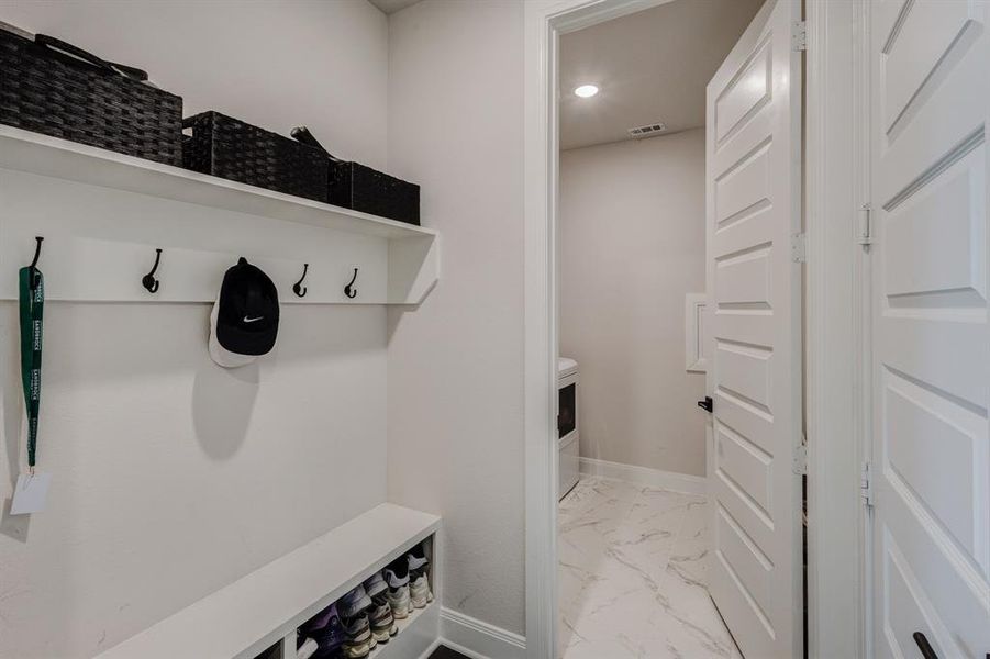 Mudroom with baseboards and light marble finish flooring