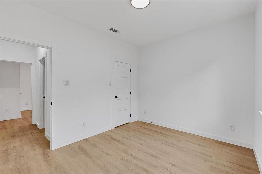 Spare room featuring light wood finished floors and baseboards Spare room featuring light wood finished floors and baseboards