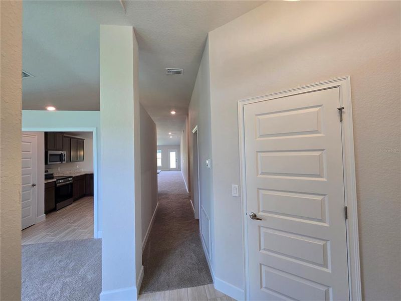 hallway to garage & bedrooms
