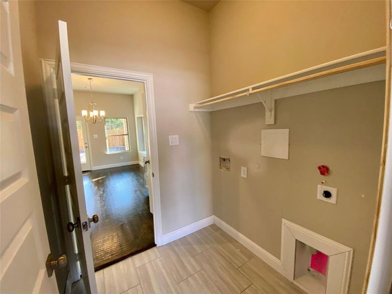 Laundry room from garage into kitchen with shelf & rod