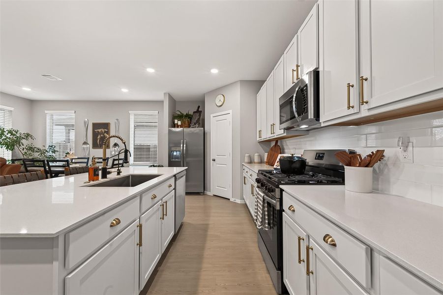 Well-appointed kitchen with ample counter space, cabinetry, and recessed lighting Well-appointed kitchen with ample counter space, cabinetry, and recessed lighting