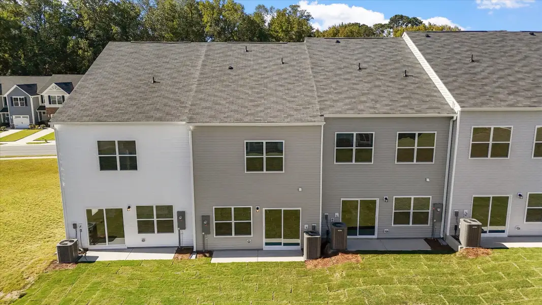 Exterior details and patio area of a home in West Main Townhomes, Sanford (Image 3).