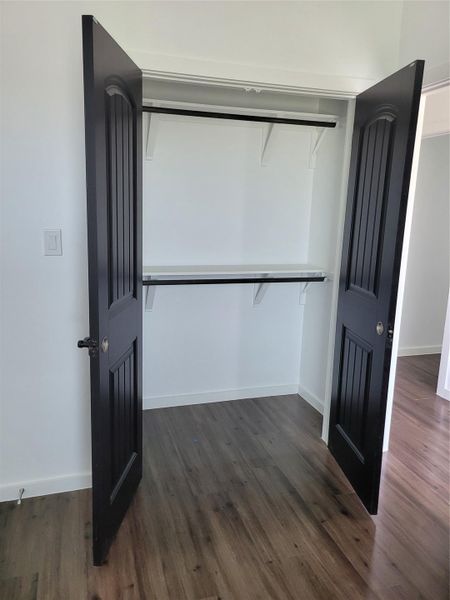 Ample closet space with shelving and hanging rods offers practical storage solutions. Ample closet space with shelving and hanging rods offers practical storage solutions.