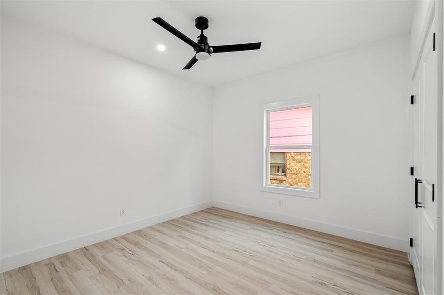 Spare room featuring ceiling fan and light wood-type flooring