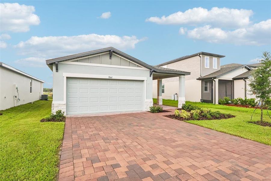 Front exterior of a new home in Villamar - Classic Series, Winter Haven, FL, highlighting curb appeal (Image 18). Front exterior of a new home in Villamar - Classic Series, Winter Haven, FL, highlighting curb appeal (Image 18).