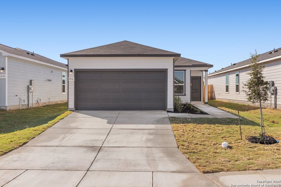 Front exterior of a new home in Punta Verde, Converse, TX, highlighting curb appeal (Image 1). Front exterior of a new home in Punta Verde, Converse, TX, highlighting curb appeal (Image 1).