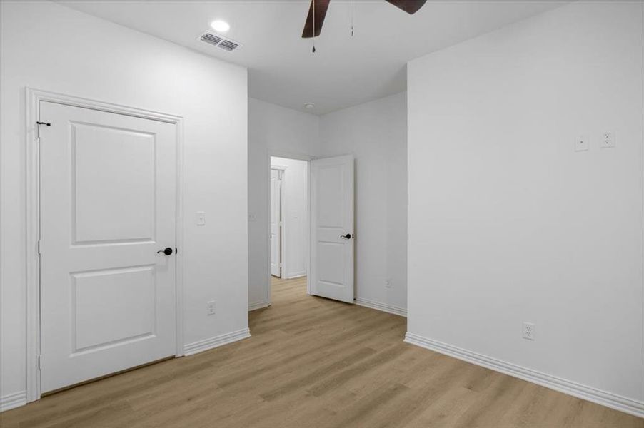 Unfurnished bedroom featuring ceiling fan and light wood-style floors