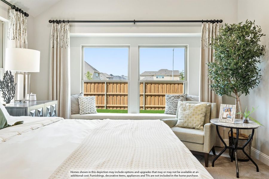 Bedroom with large windows, built-in window seat, neutral decor, and a view of the backyard fence