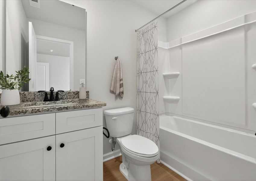 The secondary bathroom has a large soaking tub