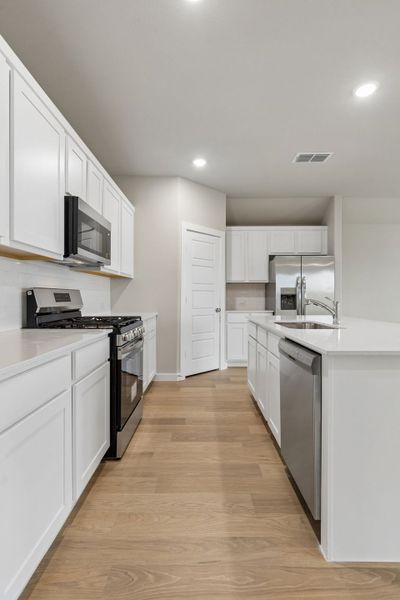 Kitchen in the Emmy II home plan by Trophy Signature Homes - REPRESENTATIVE PHOTO
