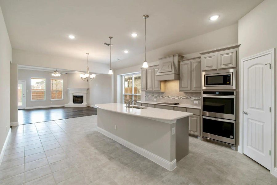 Kitchen to Family Room | Concept 2129 at Redden Farms - Classic Series in Midlothian, TX by Landsea Homes