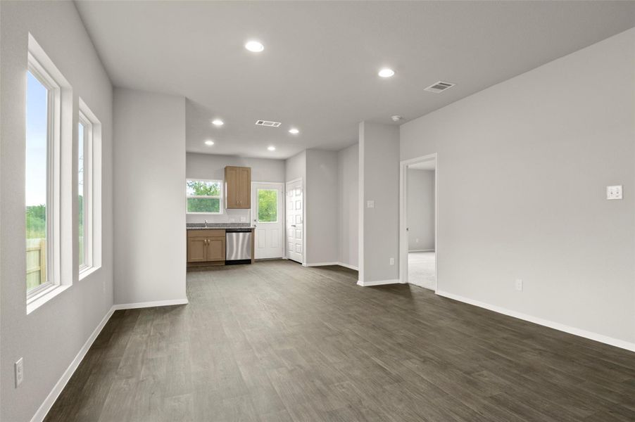Unfurnished living room with recessed lighting and dark wood-style floors