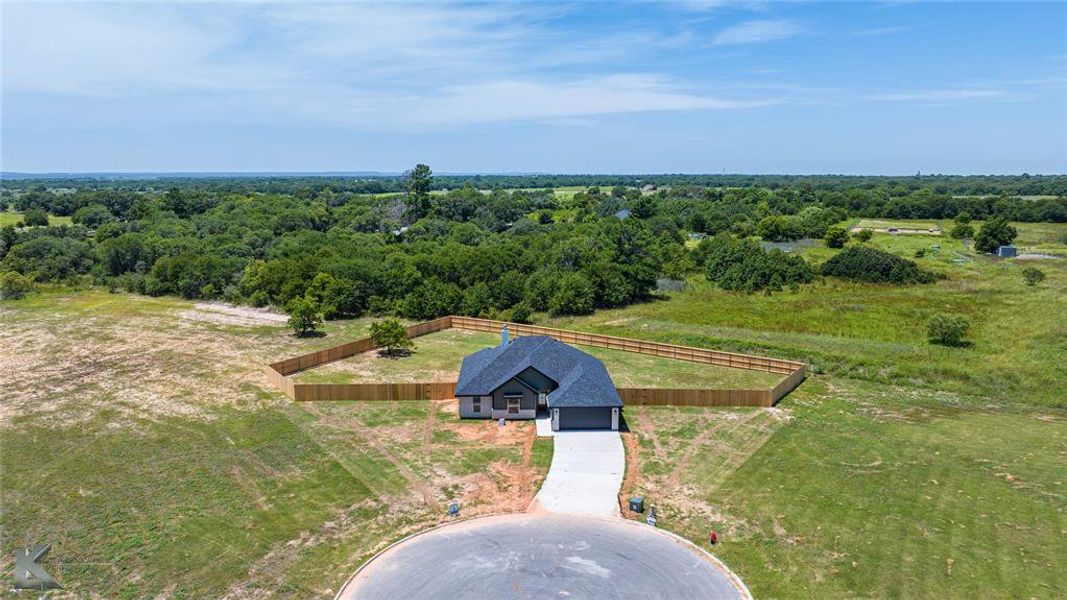View from above of property featuring a heavily wooded area