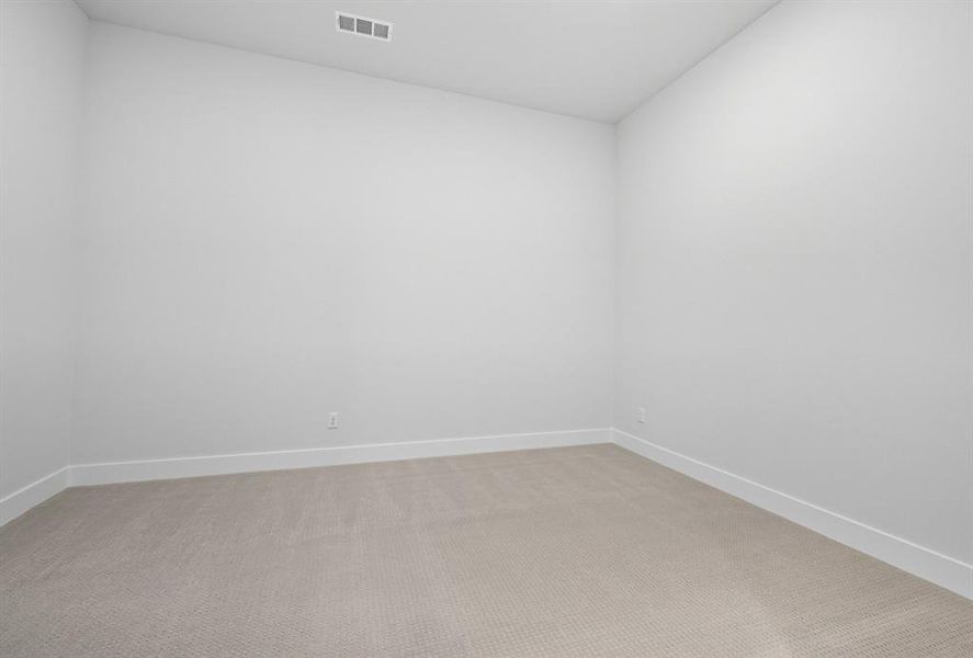 Unfurnished room with light carpet and baseboards Unfurnished room with light carpet and baseboards