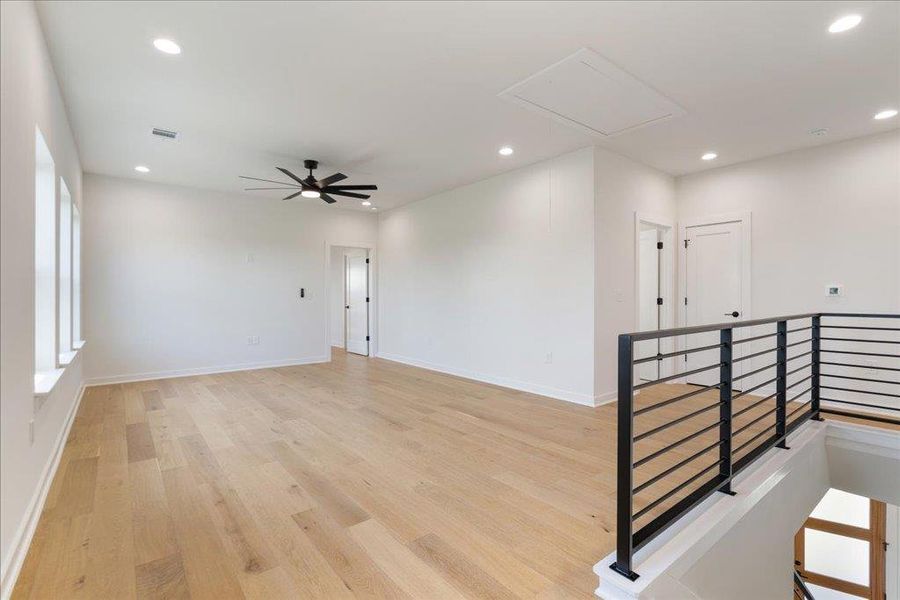 Empty room with recessed lighting, light wood-style floors, ceiling fan, and attic access