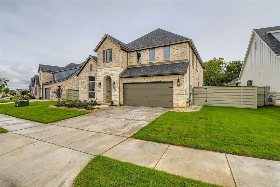 View of front of property featuring a shingled roof, driveway, a garage, a front lawn, and a gate View of front of property featuring a shingled roof, driveway, a garage, a front lawn, and a gate