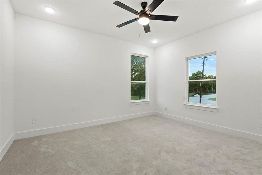 Empty room featuring light carpet, a ceiling fan, and recessed lighting Empty room featuring light carpet, a ceiling fan, and recessed lighting