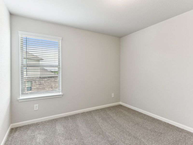 Guest bedroom in the Matador floorplan at a Meritage Homes community.