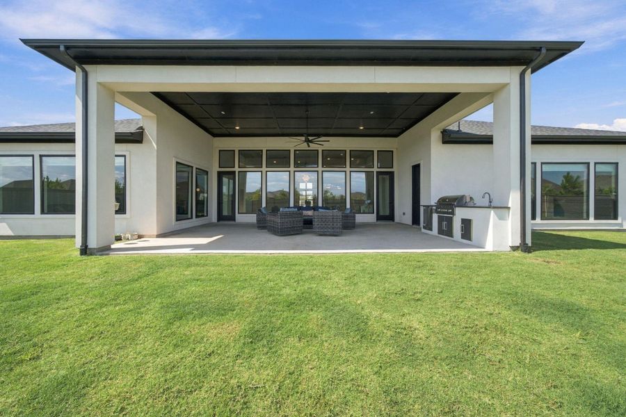 Imagine weekend cookouts and evening gatherings under this oversized covered patio, complete with a built-in grill and prep space ready to go. The expansive backyard and open sky views make this the kind of outdoor space you'll use all year long.