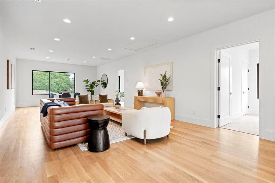 Living area featuring light wood finished floors and recessed lighting Living area featuring light wood finished floors and recessed lighting