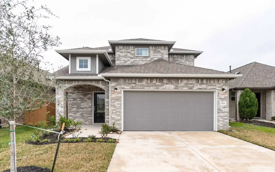 Front exterior of a new home in Lago Mar, Texas City, TX, highlighting curb appeal (Image 1).