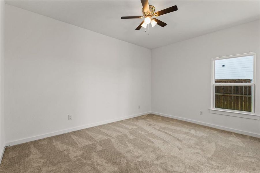 Bedroom featuring ceiling fan and light carpet