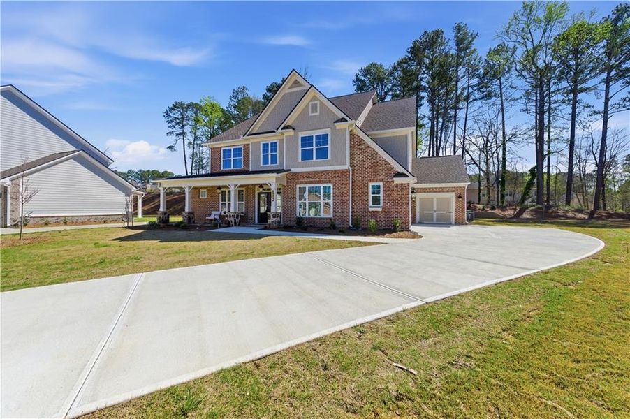 Front exterior of a new home in Ford Landing, Acworth, GA, highlighting curb appeal (Image 1). Front exterior of a new home in Ford Landing, Acworth, GA, highlighting curb appeal (Image 1).