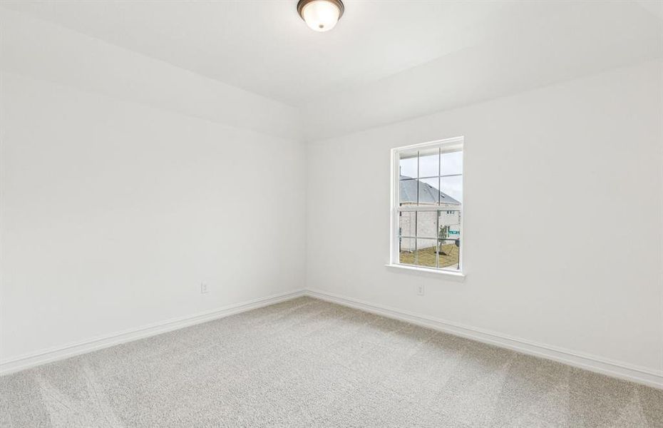 Comfortable secondary bedroom with generous closet space  *Real home pictured