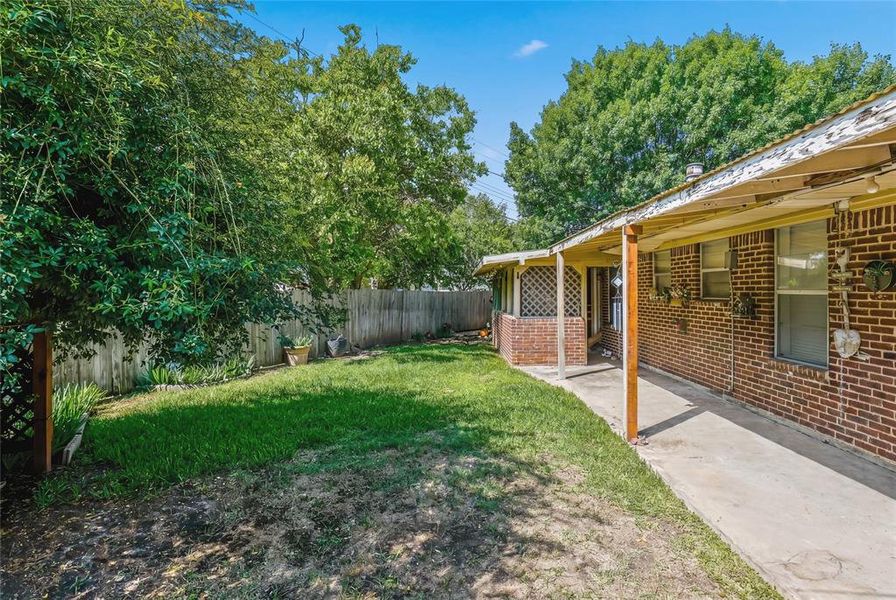 Expansive backyard featuring a manicured lawn, established trees, and a privacy fence Expansive backyard featuring a manicured lawn, established trees, and a privacy fence