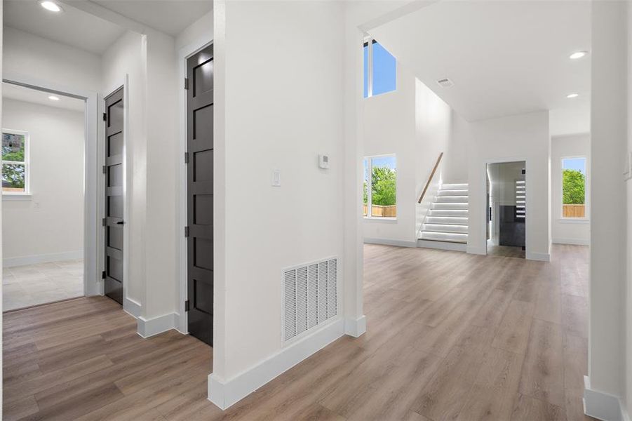 This property features light wood flooring, white walls, and dark interior doors This property features light wood flooring, white walls, and dark interior doors