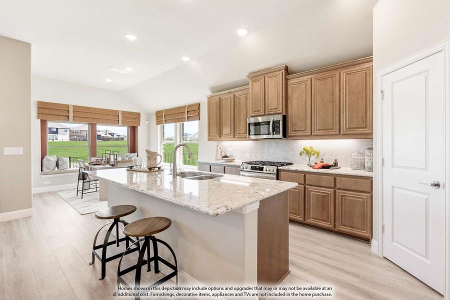 Kitchen with granite island, brown cabinets, stainless appliances, and two bar stools on light hardwood floors