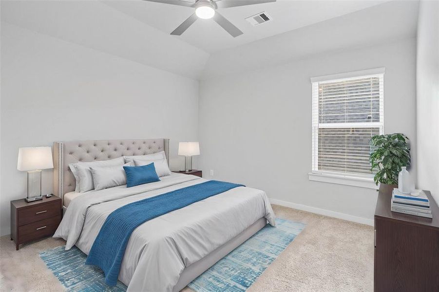 Secondary bedroom features plush carpet, custom paint, ceiling fan with lighting and a large window with privacy blinds.