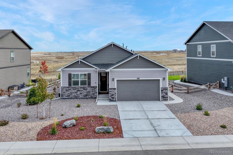 Front exterior of a new home in Spring Valley Ranch, Elizabeth, CO, highlighting curb appeal (Image 23).