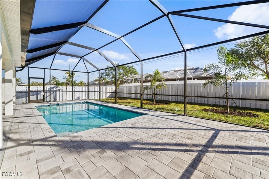 View of swimming pool with a sunroom, a lanai, a fenced backyard, and a patio area