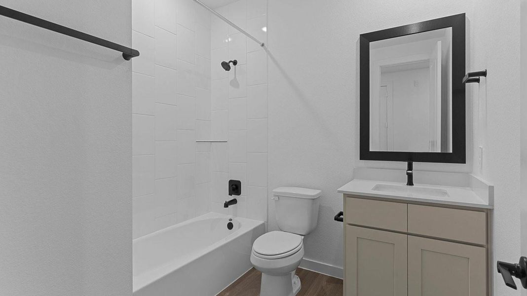 A well-designed bathroom equipped with quartz countertops, a standing tub, and a single vanity.