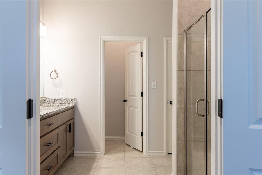 Main Bath with stand alone shower and large storage closet along with large walk in closet