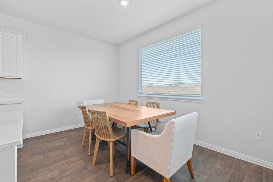 Dining space featuring dark wood finished floors and recessed lighting Dining space featuring dark wood finished floors and recessed lighting