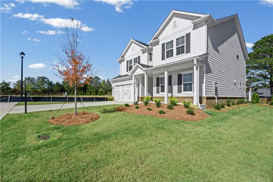 Front exterior of a new home in Berkeley Mill, Cumming, GA, highlighting curb appeal (Image 2). Front exterior of a new home in Berkeley Mill, Cumming, GA, highlighting curb appeal (Image 2).